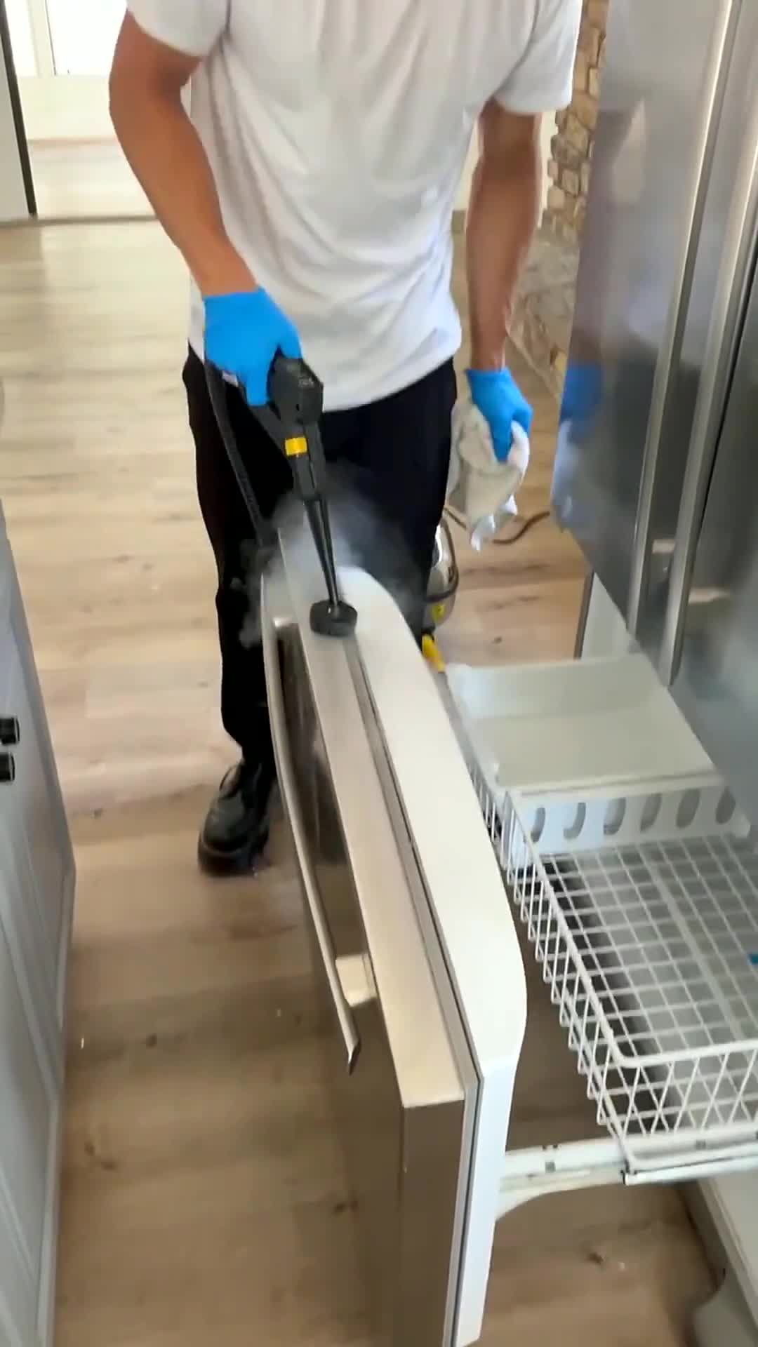 Our team steam cleaning the lower freezer section of a French door refrigerator